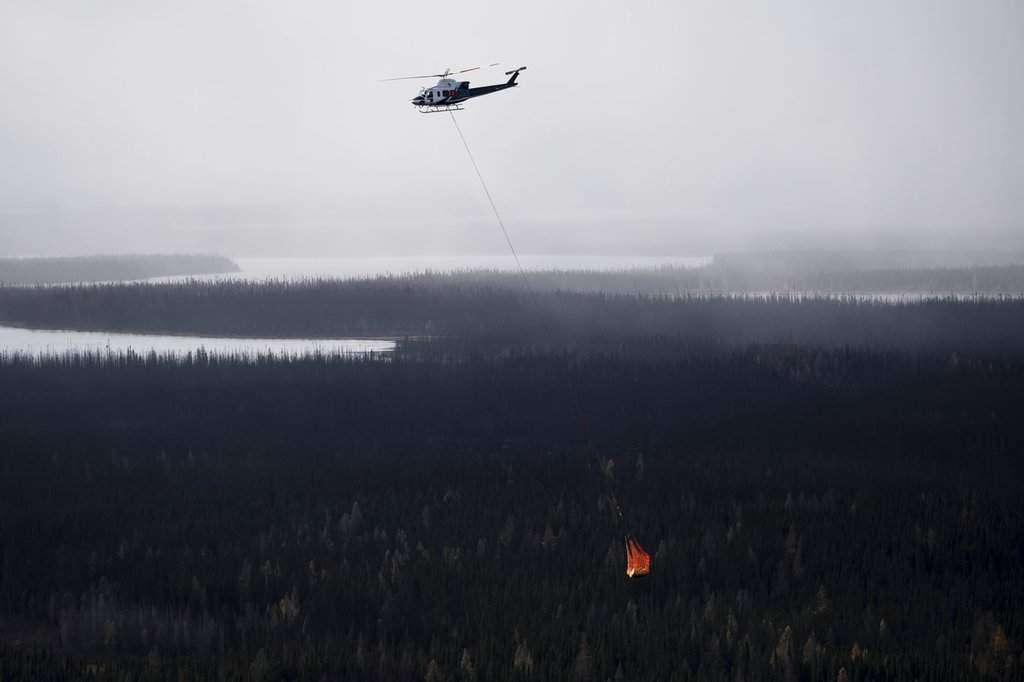 A helicopter moves equipment fuel between work sites near the Ring of Fire mineral deposit in the James Bay lowlands of northern Ontario, Friday, Oct. 24, 2025. THE CANADIAN PRESS/Christopher Katsarov.