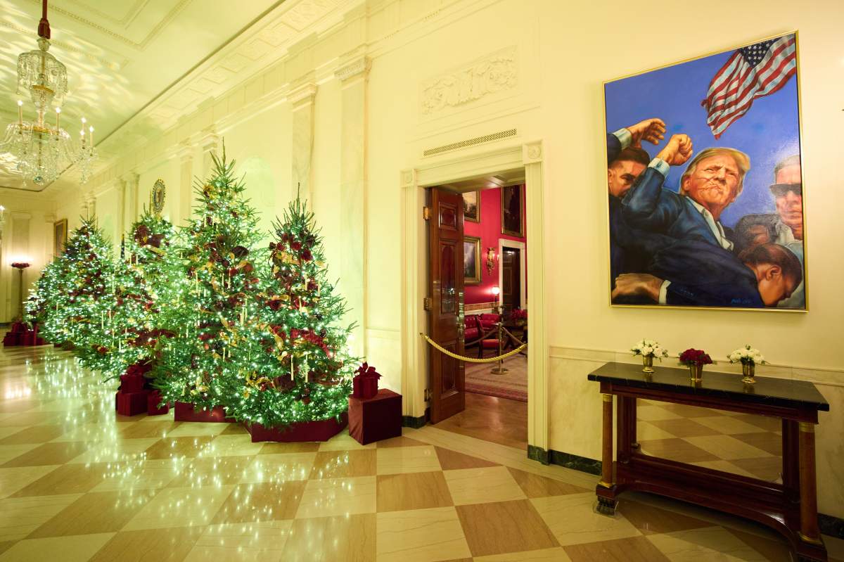 Christmas trees decorate the Cross Hall of the White House during a press preview of the Christmas decorations 'Home is Where the Heart Is,' Monday, Dec. 1, 2025, in Washington.