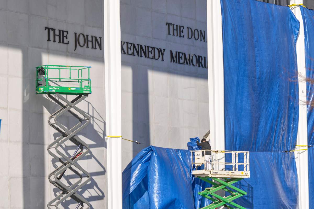 A worker on a forklift stands near the letters "The Donald" above the signage on the Kennedy Center on Friday, Dec. 19, 2025, in Washington.