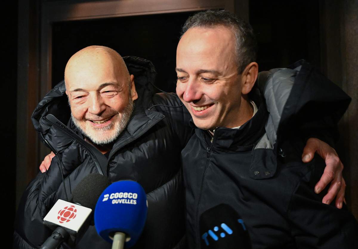 Daniel Jolivet, left, hugs his lawyer Nicholas St-Jacques outside the Montreal Courthouse in Montreal, Friday, Dec. 19, 2025, after being released on bail. Jolivet spent 33 years in prison for murders he said he didn’t commit.