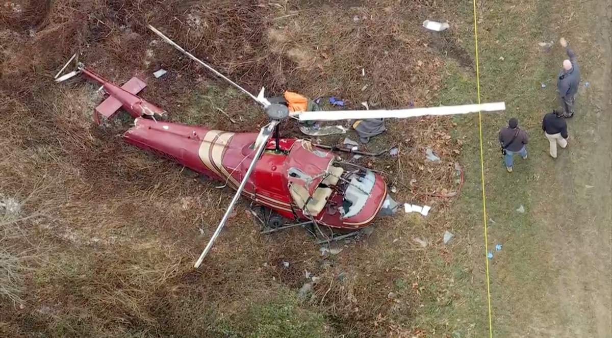 Authorities look over the scene after two helicopters crashed in Hammonton, N.J., on Sunday, Dec. 28, 2025.