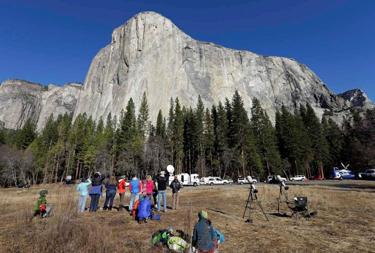 FILE: Spectators gaze at El Capitan for a glimpse of climbers Tommy Caldwell and Kevin Jorgeson on Jan. 14, 2015, as seen from the valley floor in Yosemite National Park, Calif.