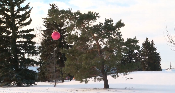 An Edmonton man attempts to recreate an iconic Christmas tree from a kid’s holiday special by an ornament on a slanted tree.