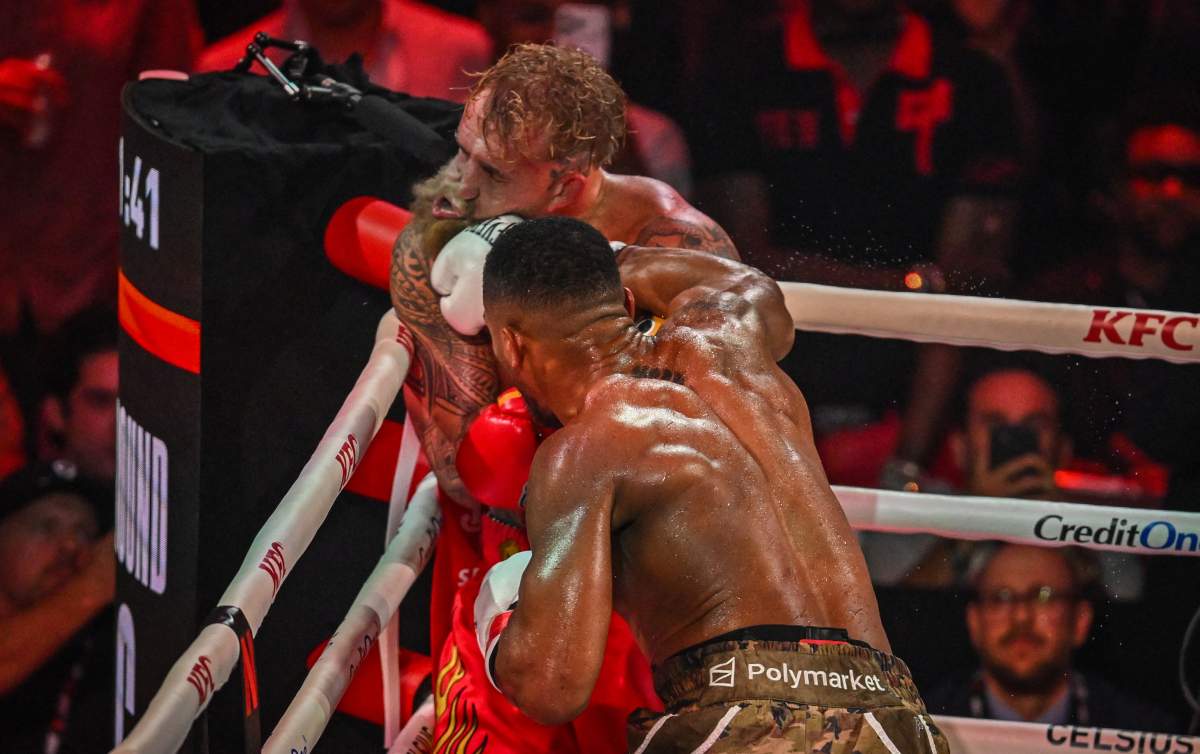 US boxer and influencer Jake Paul (L) and British boxer Anthony Joshua fight in a non-title heavyweight bout at the Kaseya Center in Miami, Florida on December 19, 2025.