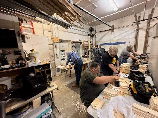 Men work on tools with the Men's Shed Program