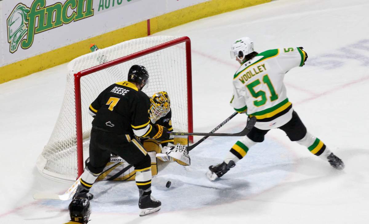 Jared Woolley of the London Knights is denied by Patrick Quinlan of the Sarnia Sting on a chance in tight in a game played on Dec. 31, 2025 at Canada Life Place.