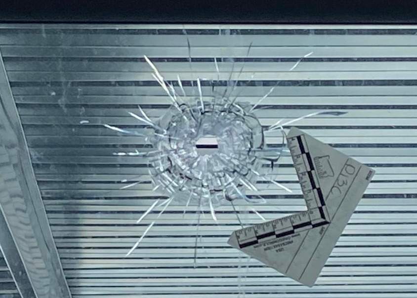 Bullet hole in window which Dharmjit Mand said was part of an extortion attempt by India's Bishnoi gang.