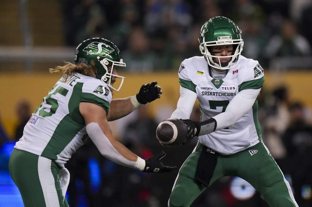Saskatchewan Roughriders quarterback Trevor Harris (7) passes to Saskatchewan Roughriders' A.J. Ouellette (45) as they take on Montreal Alouettes in first half CFL football action at the 112th Grey Cup, in Winnipeg on Sunday, Nov. 16, 2025.