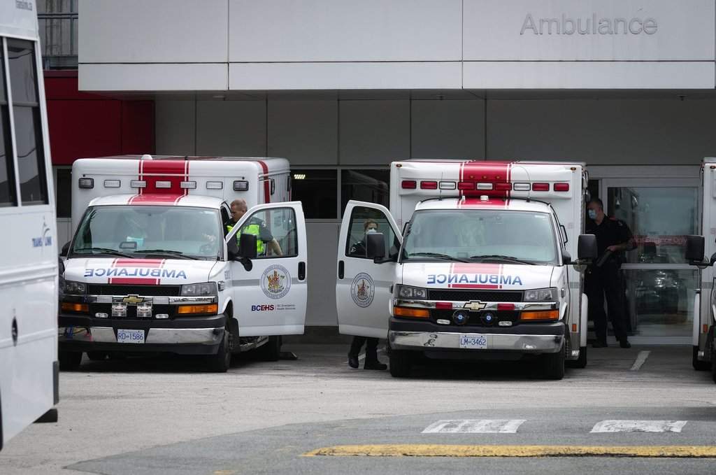 Paramedics and ambulances are seen outside the emergency department at Burnaby Hospital in Burnaby, B.C., on Monday, May 30, 2022. 