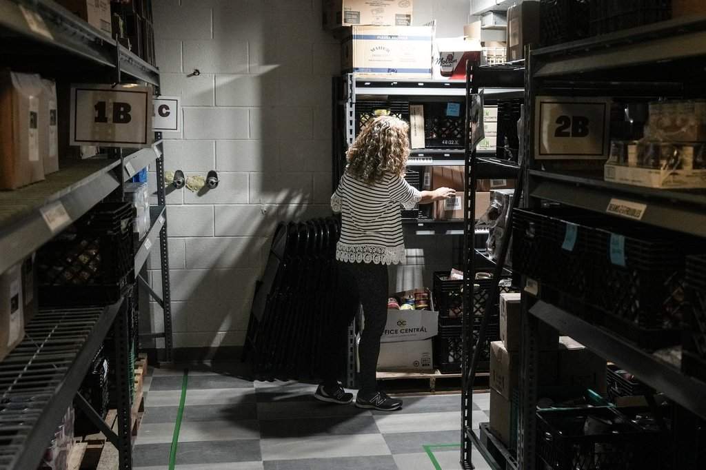 A volunteer works in the storeroom of St. Philip Neri’s Table Food Bank at St Philip Neri Church in Toronto, Friday, Oct. 25, 2024. 