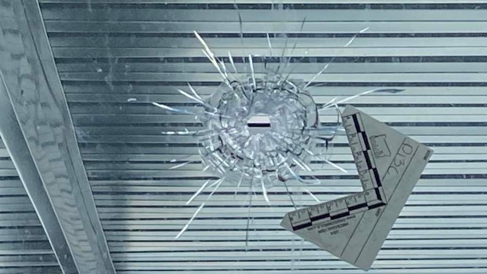 Bullet hole in glass which Dharmjit Mand said was part of an extortion attempt against him.
