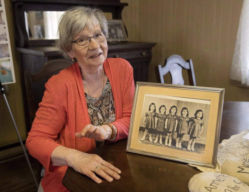 Annette Dionne, one of the famous 'Dionne Quintuplets,' is pictured at the original cabin she was born in, which was relocated to downtown North Bay, Ont., next to the North Bay Museum, on Aug. 5, 2018. Annette died in Montreal on Wednesday at the age of 91. She was the last surviving quintuplet.