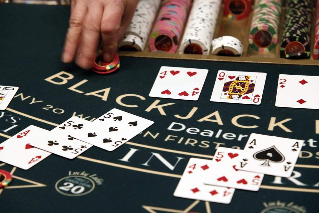 A dealer slides chips across the blackjack table on Friday, March 16, 2012, in Bangor, Maine. THE CANADIAN PRESS/AP-Robert F. Bukaty.