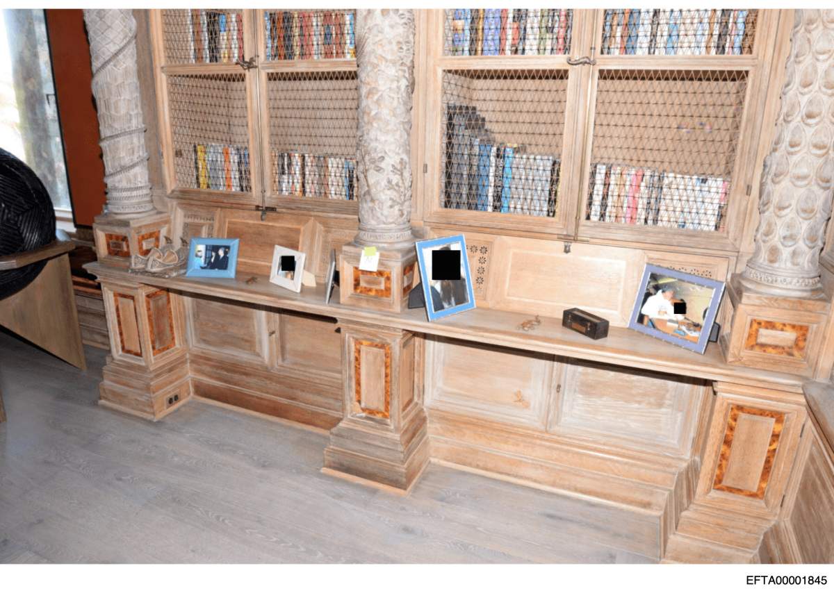 This redacted photo released by the U.S. Department of Justice shows a collection of framed photographs, documented on Aug. 12, 2019, during a search of Jeffrey Epstein's home