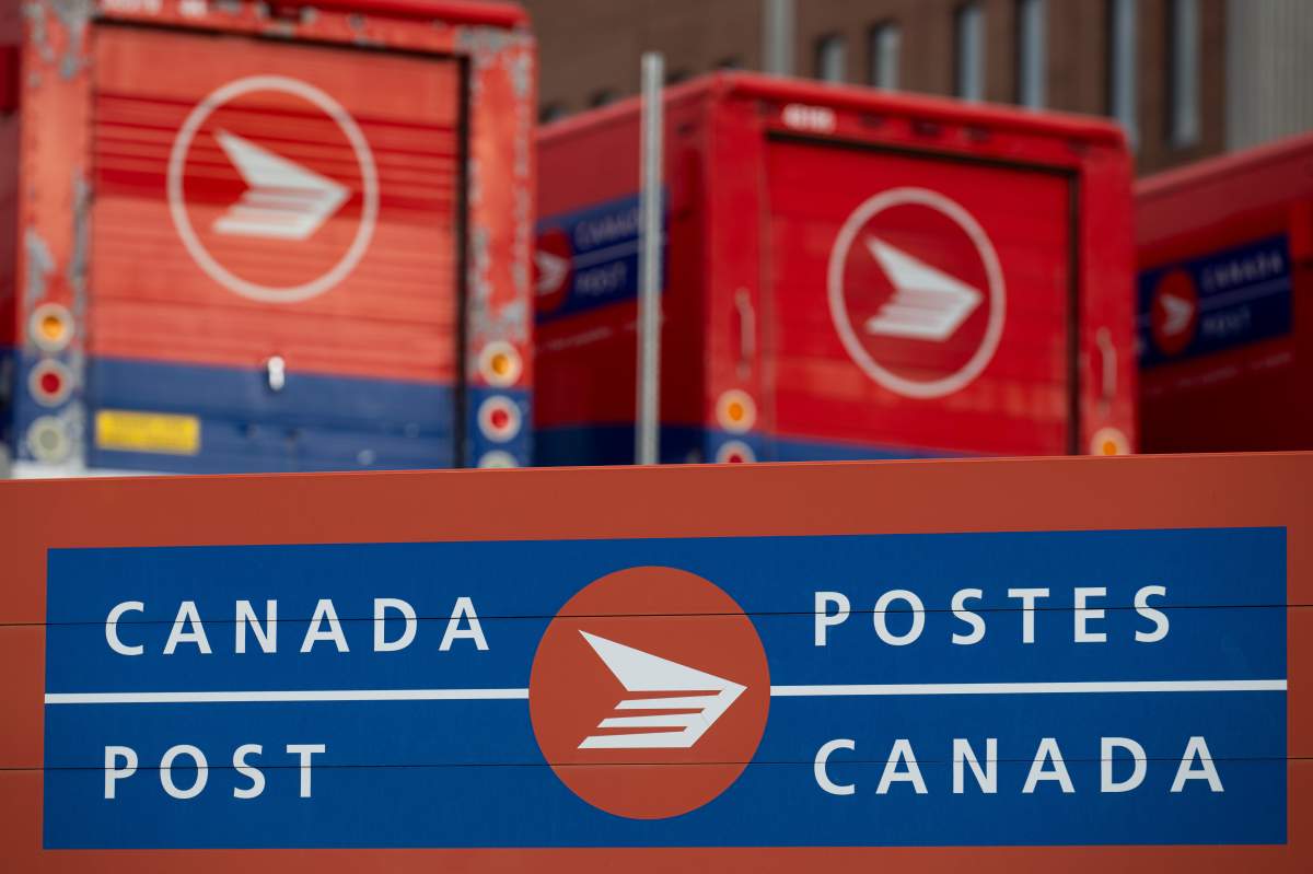 Canada Post signage and parked vehicles are seen at a Canada Post mail sorting facility during nation-wide strike action in Ottawa, on Monday, Nov. 18, 2024.