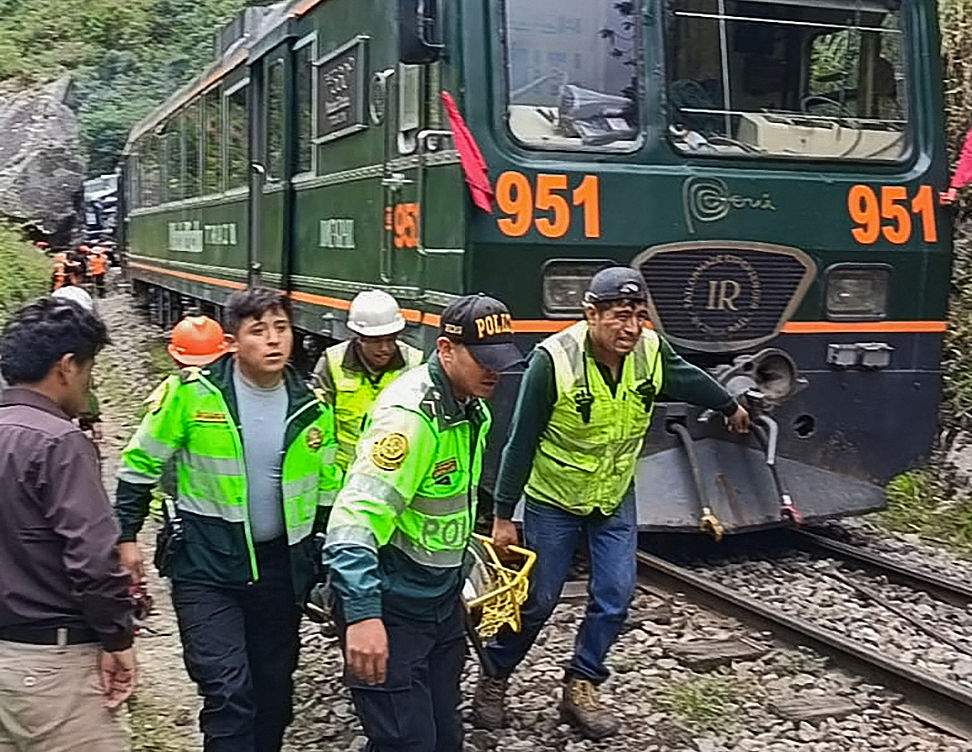 Police officers carry an injured passenger from one of the two trains involved in a head-on collision connecting Machu Picchu with Ollantaytambo in Pampacahua, Cusco Department, Peru, on Dec. 30, 2025. At least one person died and dozens of others were injured when the two tourist trains collided. (Photo by Carolina Paucar / AFP via Getty Images).