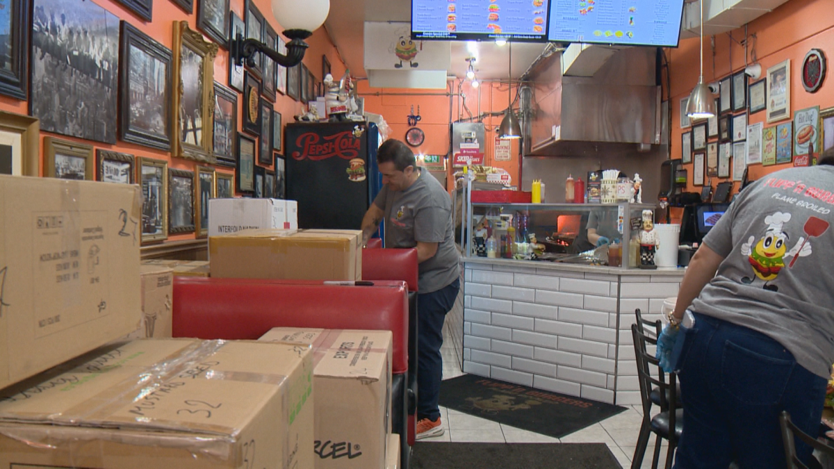 Workers fill boxes with burgers