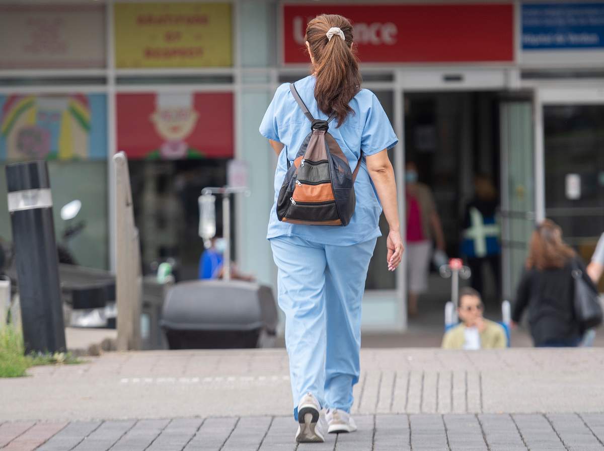 A healthcare worker is shown outside a hospital in Montreal.