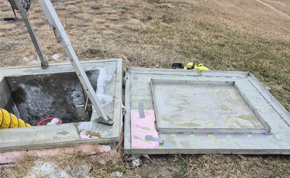 The reservoir hatch that was tampered with in Outlook, Sask. sits open as it’s inspected by officials. The hatch was not found wide open as pictured when the tampering occurred.