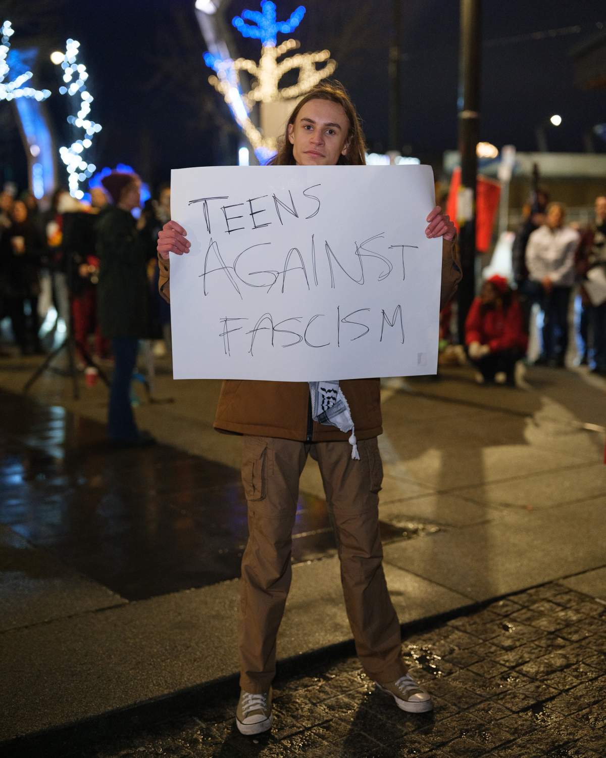 A protester holding a sign outside the protest on Friday, Jan. 30.