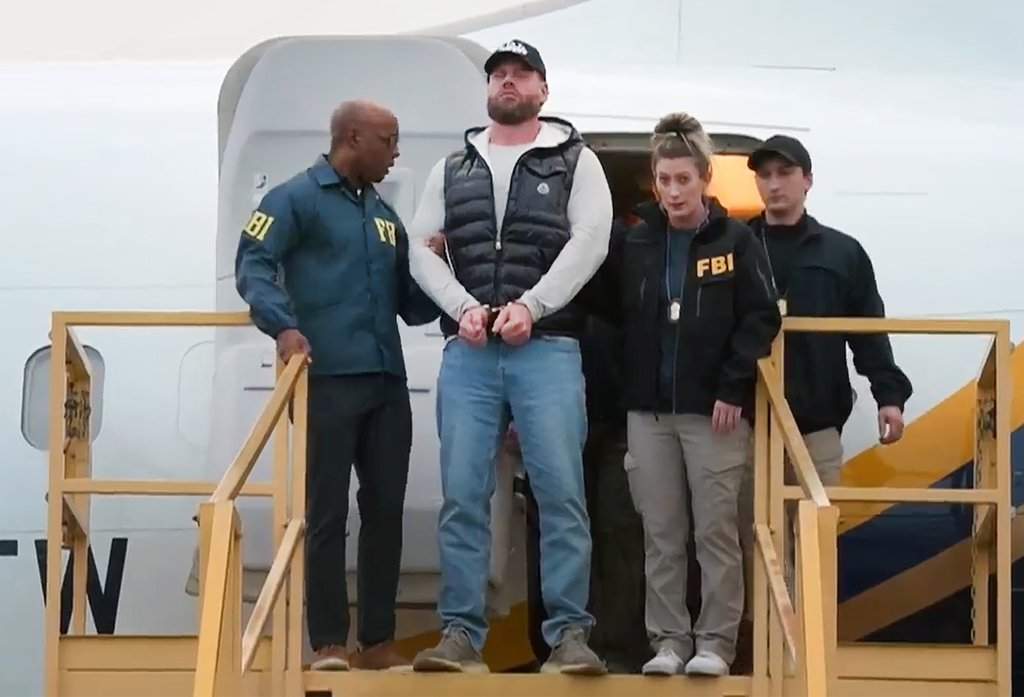 This still photo taken from video and provided by the FBI shows Ryan Wedding, a former Canadian Olympic snowboarder facing charges related to drug trafficking and the killing of a federal witness, is taken off a plane at Ontario International Airport in Ontario, Calif., on Friday, Jan. 23, 2026. (FBI via AP)