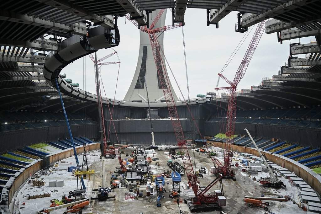 Cranes are shown inside the Olympic Stadium during the replacement of the roof in Montreal, Thursday, Jan. 8, 2026. THE CANADIAN PRESS/Graham Hughes.