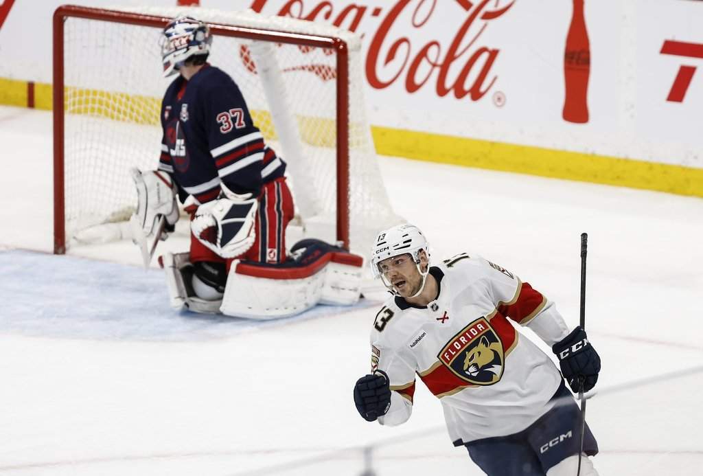 The Florida Panthers' Sam Reinhart (13) celebrates his goal against Winnipeg Jets goaltender Connor Hellebuyck (37) in shootout NHL action in Winnipeg on Thursday, Jan. 22, 2026.