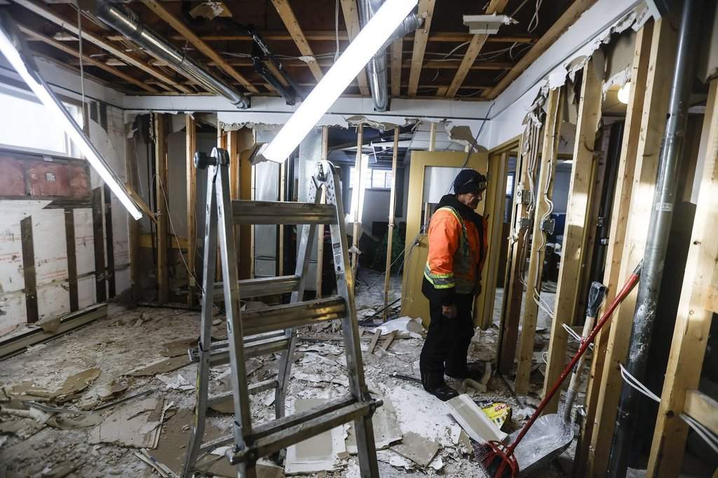 Crews work to clean up the basement of a home on the Pimicikamak Cree Nation, which was destroyed due to water damage during recent infrastructure failures, during a tour with politicians and media at Pimicikamak Cree Nation, Man., on Jan. 7, 2026. THE CANADIAN PRESS/John Woods