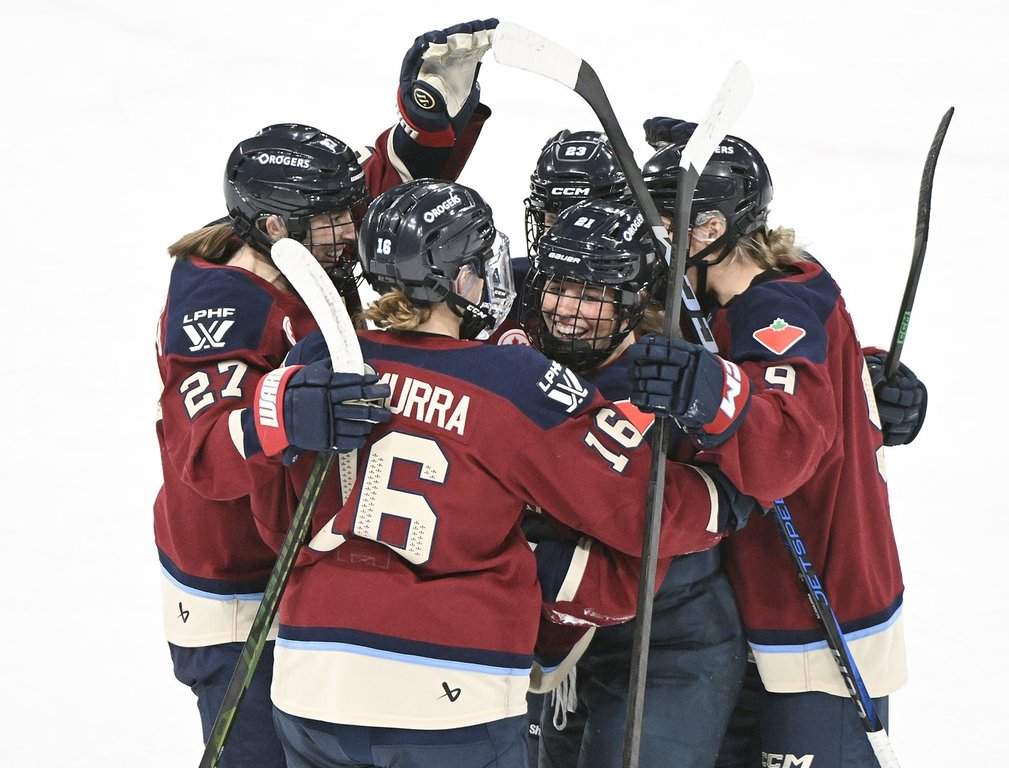 Montreal Victoire's Maureen Murphy (21) celebrates with teammates Hayley Scamurra (16) Shiann Darkangelo (27), Erin Ambrose (23) and Kati Tabin (9) after scoring against the Ottawa Charge during first period PWHL hockey action in Laval, Que., Saturday, Jan. 24, 2026. THE CANADIAN PRESS/Graham Hughes.