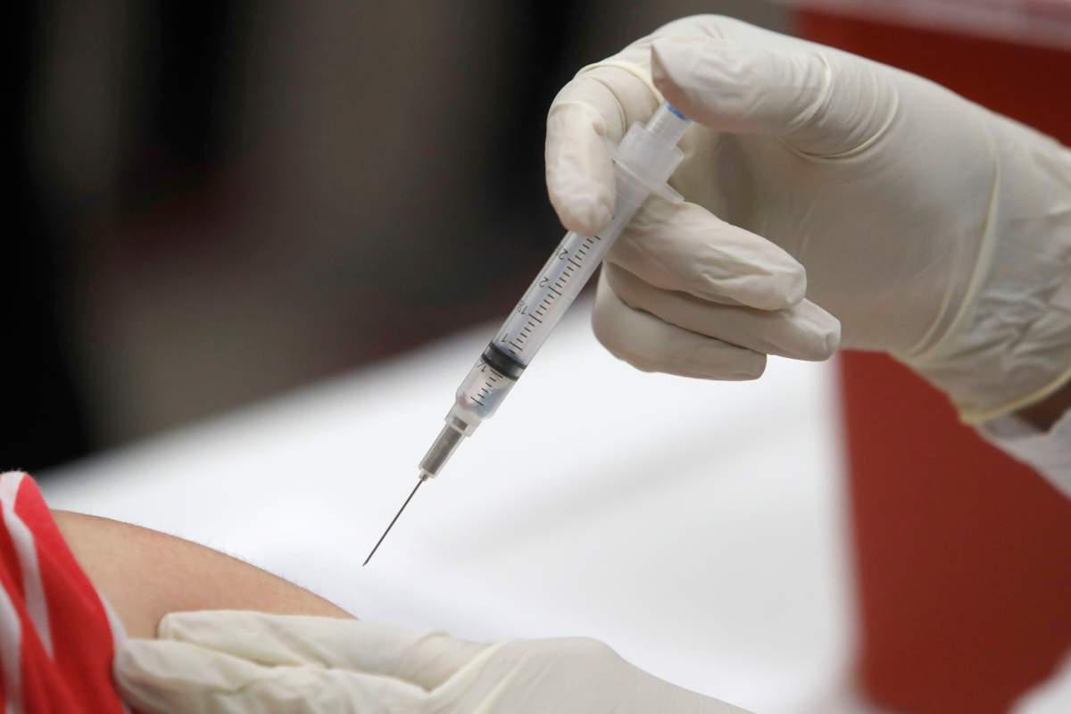 A patient receives an influenza vaccine in Mesquite, Texas.