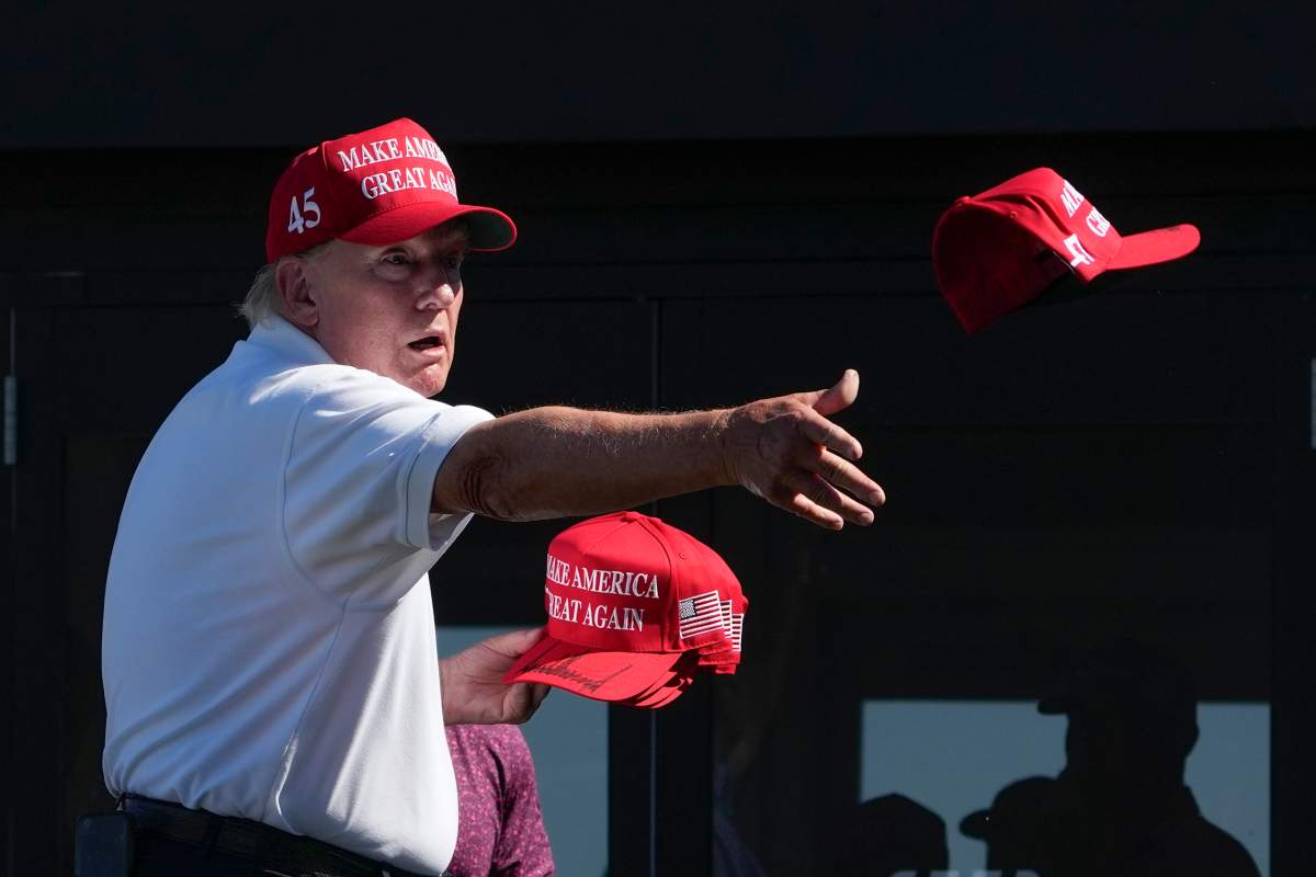 FILE - Former President Donald Trump throws autographed hats to the crowd during the final round of the Bedminster Invitational LIV Golf tournament in Bedminster, N.J., Sunday, Aug. 13, 2023.