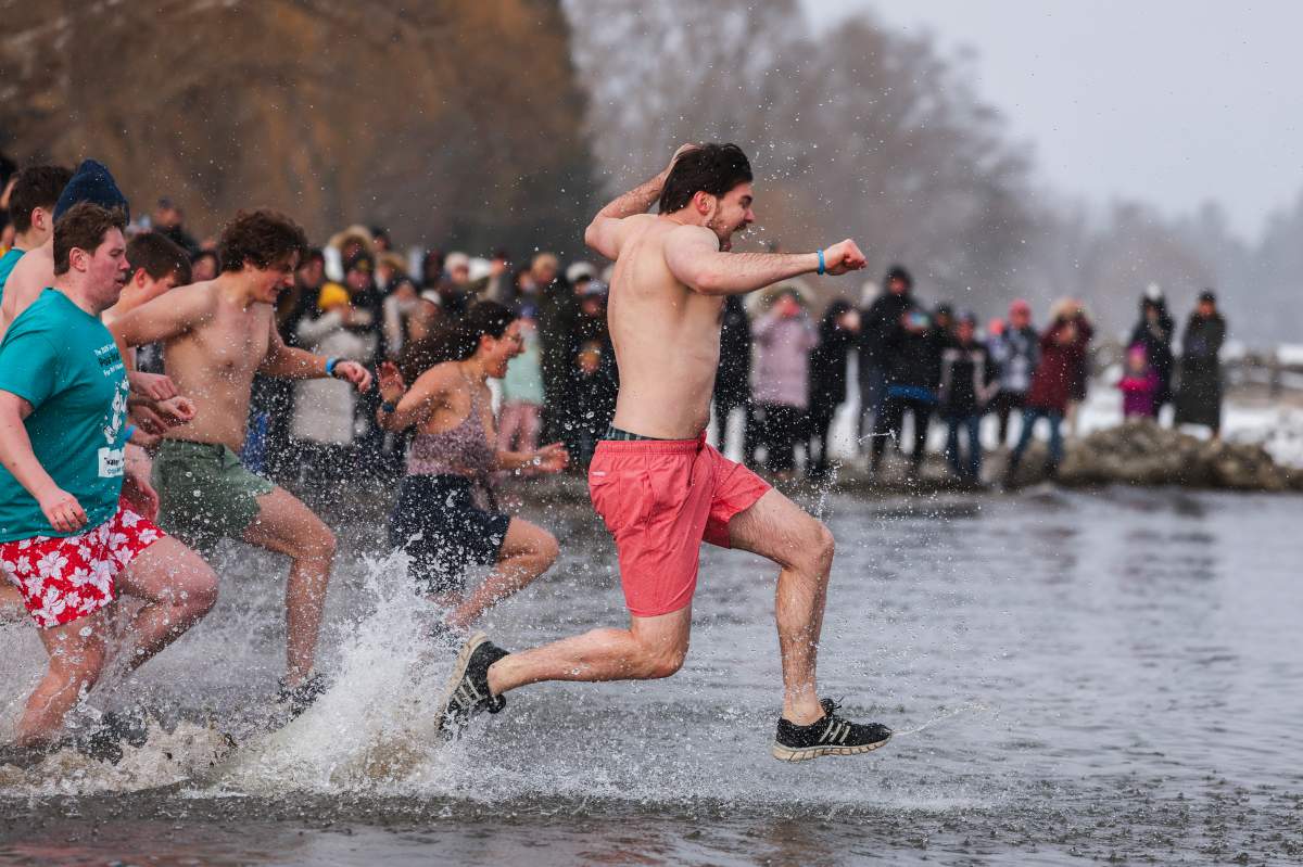 People participate in the annual polar bear dip on New Year’s Day in Oakville, Ont., Thursday, Jan. 1, 2026. THE CANADIAN PRESS/Nick Iwanyshyn