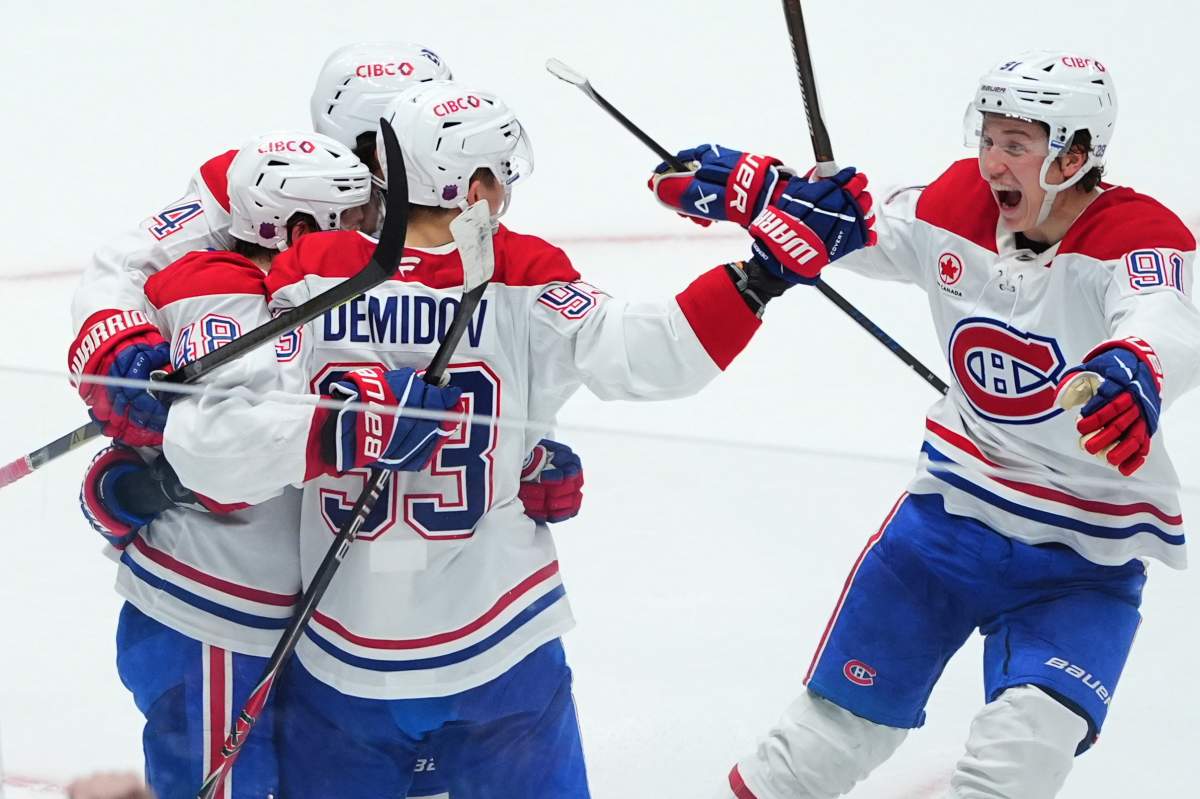 Montréal Canadiens defenseman Lane Hutson (48) celebrates after his overtime goal with right wing Ivan Demidov (93), center Phillip Danault (24) and center Oliver Kapanen (91) during an NHL hockey game against the Dallas Stars, Sunday, Jan. 4, 2026, in Dallas. 