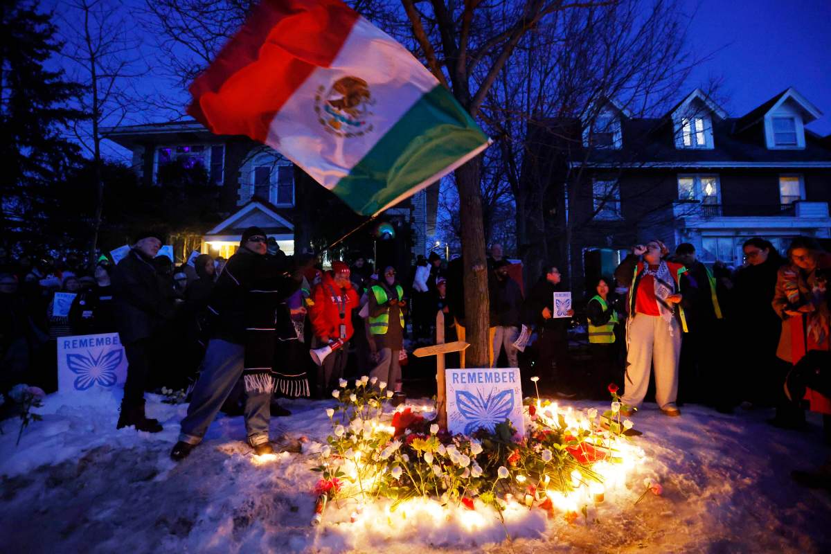 People gather for a vigil after an Immigration and Customs Enforcement officer shot and killed a woman earlier in the day, Wednesday, Jan. 7, 2026, in Minneapolis.