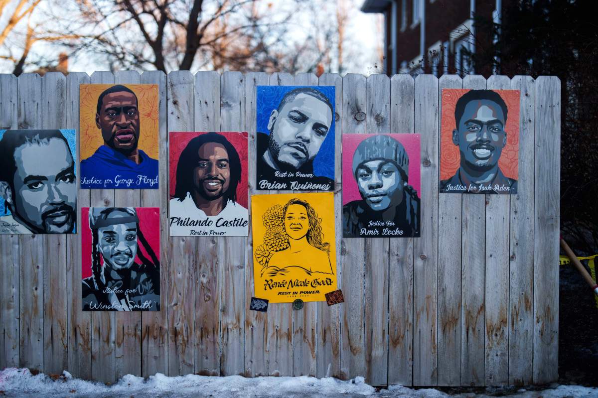 A poster depicting Renee Good, who was fatally shot by an ICE officer last week, is displayed on a fence alongside other people who were killed by police, in Minneapolis.