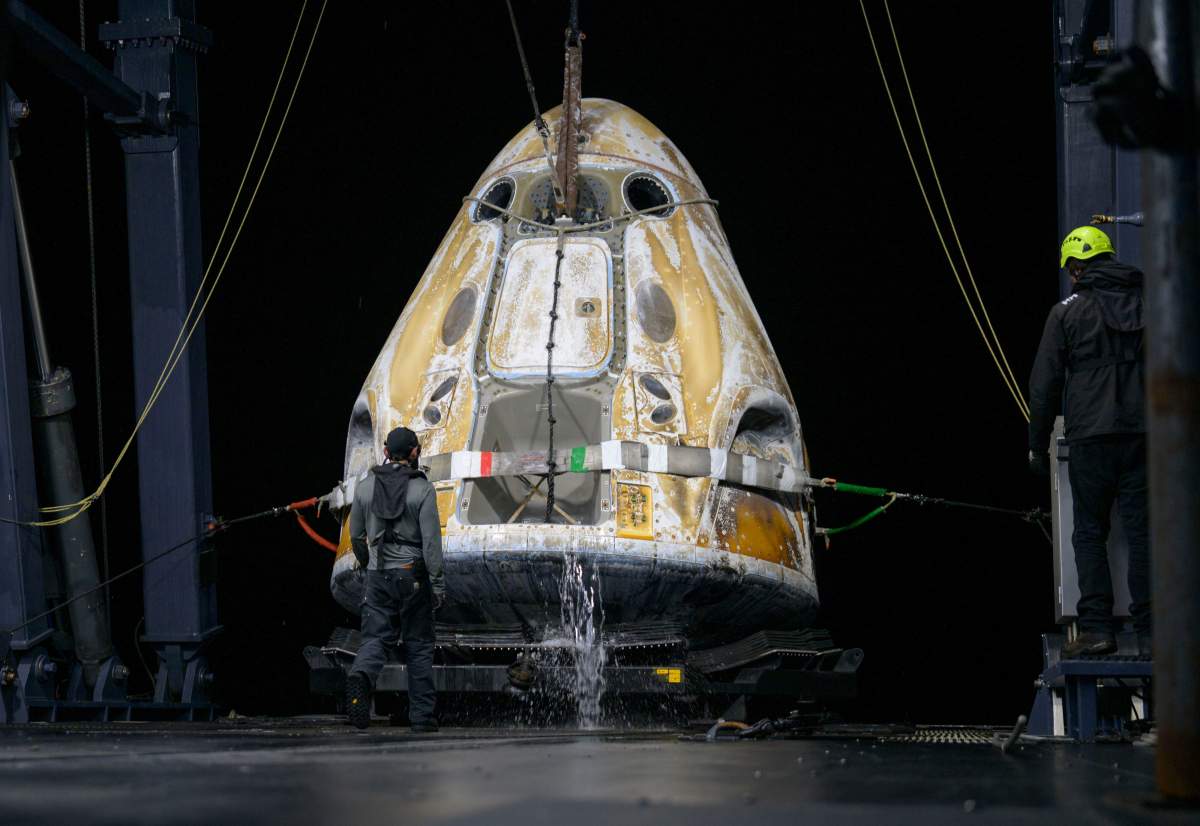 Support teams onboard the SpaceX recovery ship SHANNON work around the SpaceX Dragon Endeavour spacecraft shortly after it landed off the coast of Long Beach, Calif., Thursday, Jan. 15, 2026.