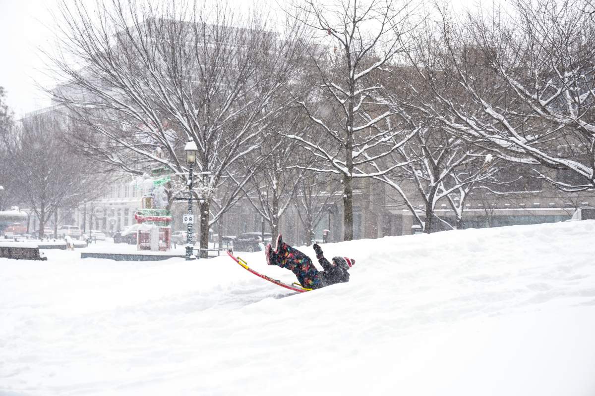 A child plays in a parkette in downtown Toronto, as a snow storm forces school closures in the city, on Jan. 15, 2026.