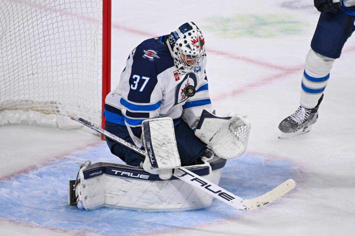 Winnipeg Jets goaltender Connor Hellebuyck (37) stops a Minnesota Wild shot during the second period of an NHL hockey game Thursday, Jan. 15, 2025, in St. Paul, Minn. (AP Photo/Craig Lassig).