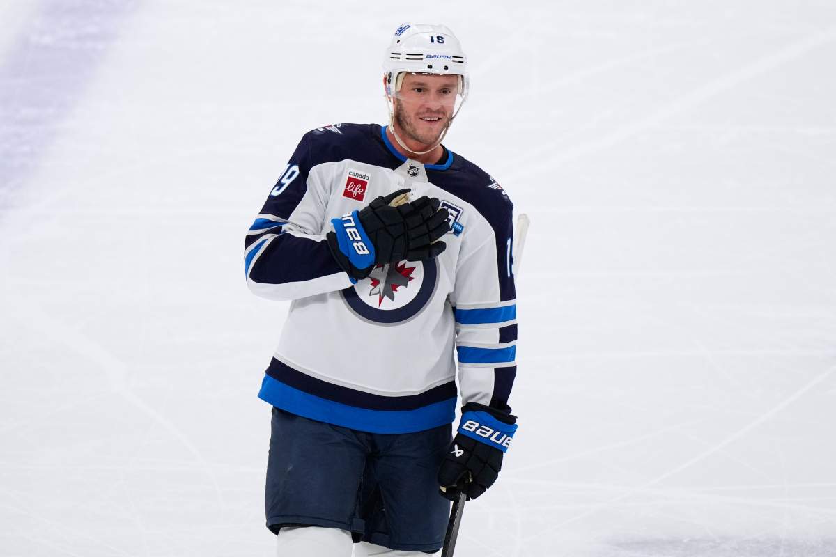 Winnipeg Jets centre Jonathan Toews greets the crowd during the first period of an NHL hockey game against the Chicago Blackhawks in Chicago on Jan. 19, 2026. (AP Photo/Nam Y. Huh).