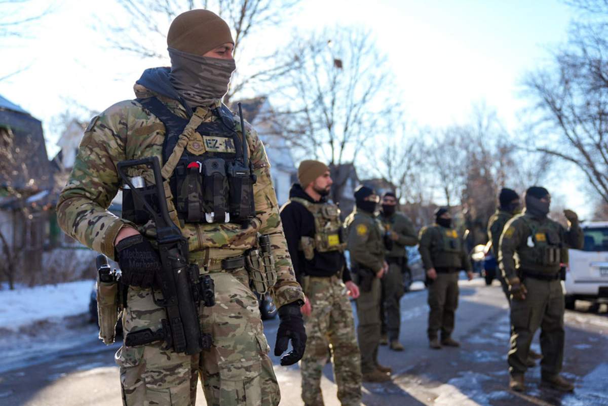ICE agents stand in the street near 31st Avenue North and 3rd Street on Jan. 14, 2026, in Minneapolis.