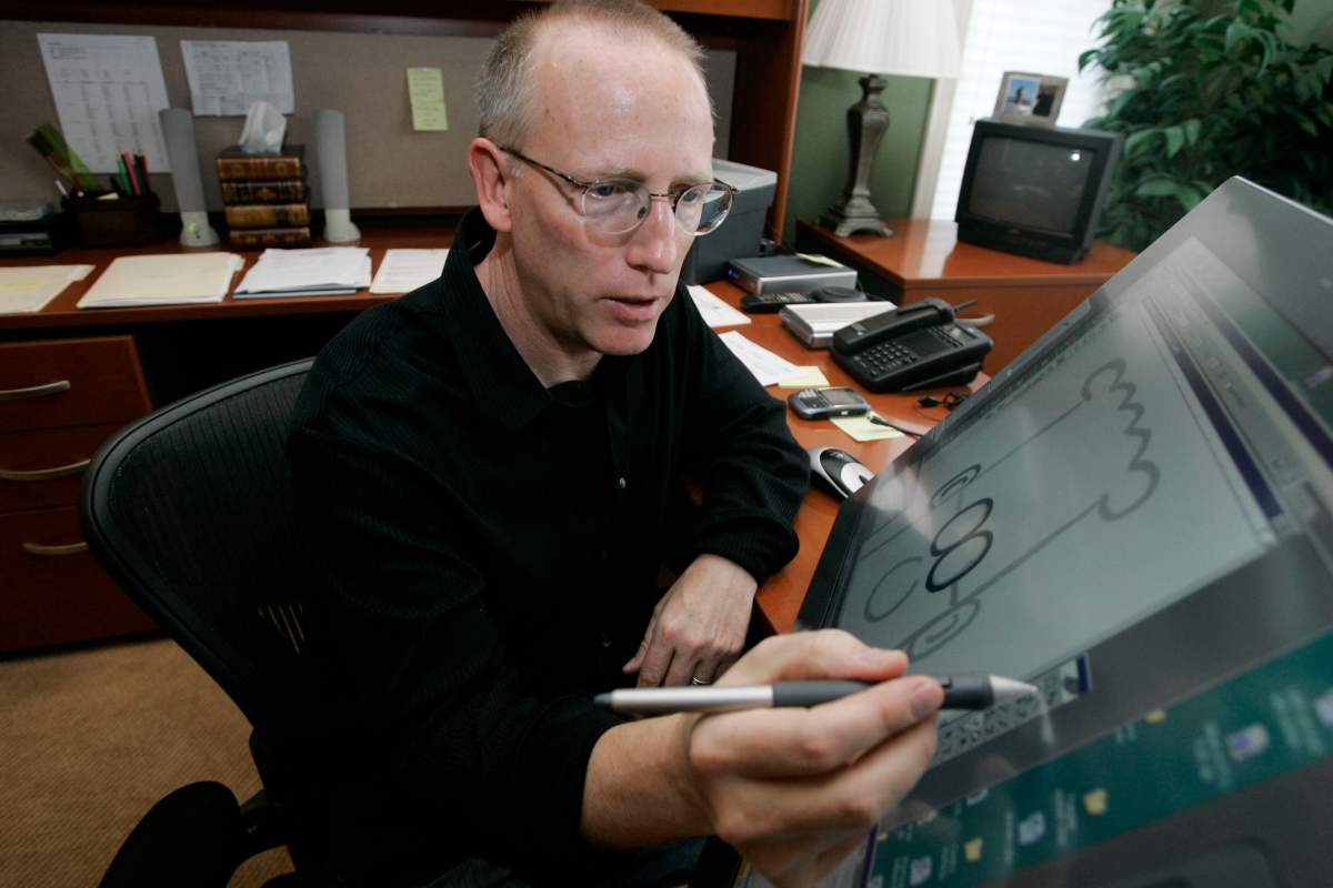 FILE - Scott Adams, creator of Dilbert, works on his comic strip in his studio in in Dublin, Calif., on Oct. 26, 2006.
