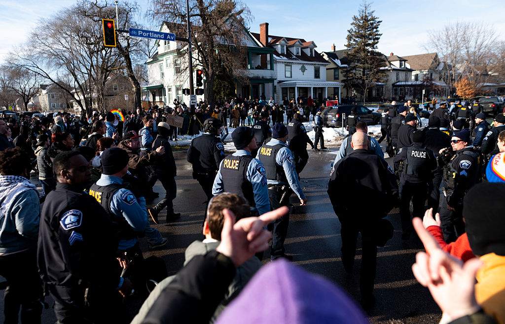 (EDITORS NOTE: Image contains profanity.) People confront Minneapolis Police officers as they leave the scene following a shooting by an ICE agent during federal law enforcement operations on January 07, 2026 in Minneapolis, Minnesota.