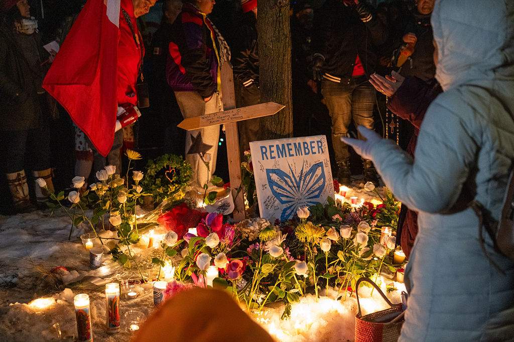 A memorial set up by community members during a vigil following a fatal shooting by an Immigration and Customs Enforcement (ICE) agent in Minneapolis, Minnesota.