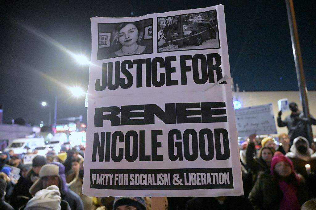 A demonstrator holds a sign reading 'Justice for Renee Nicole Good' during an emergency vigil and protest held under the Little Village Arch on January 07, 2026, in Chicago, Illinois. The emergency vigil and protest were organized by the Little Village Community Council and local activists in response to the fatal shooting of Renee Nicole Macklin Good, a 37-year-old U.S. citizen.