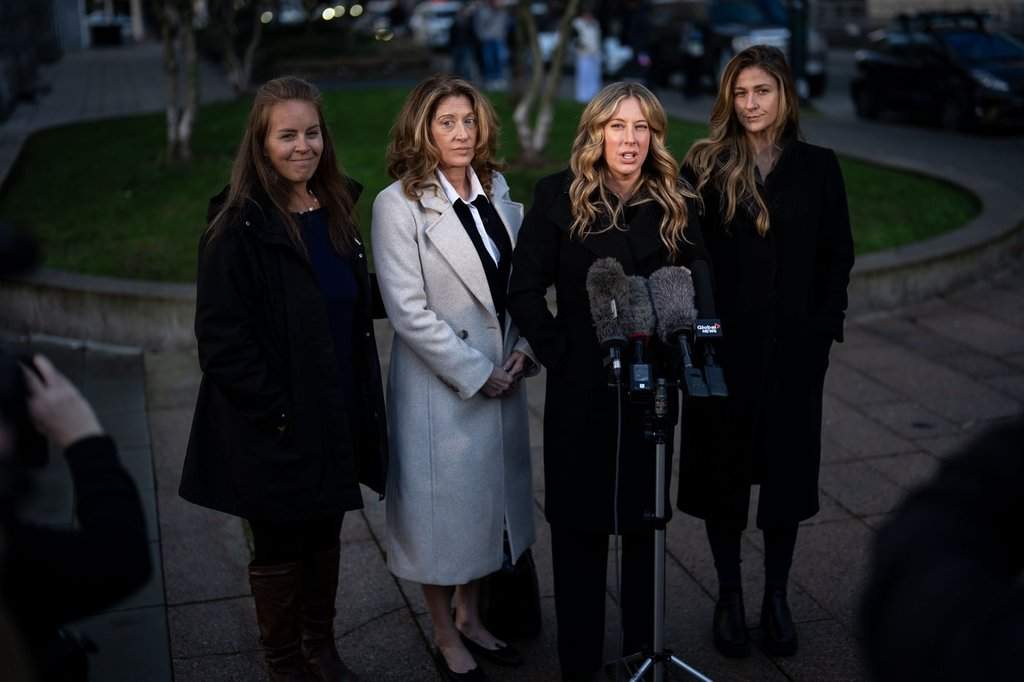 Melissa Gray, third from the left, speaks about her brother, Myles Gray during a break from the public hearing into the police-involved death of Myles Gray, flanked by mother, Margie Gray, second from left, along with friends in Vancouver, on Monday, January 19, 2026. THE CANADIAN PRESS/Ethan Cairns.