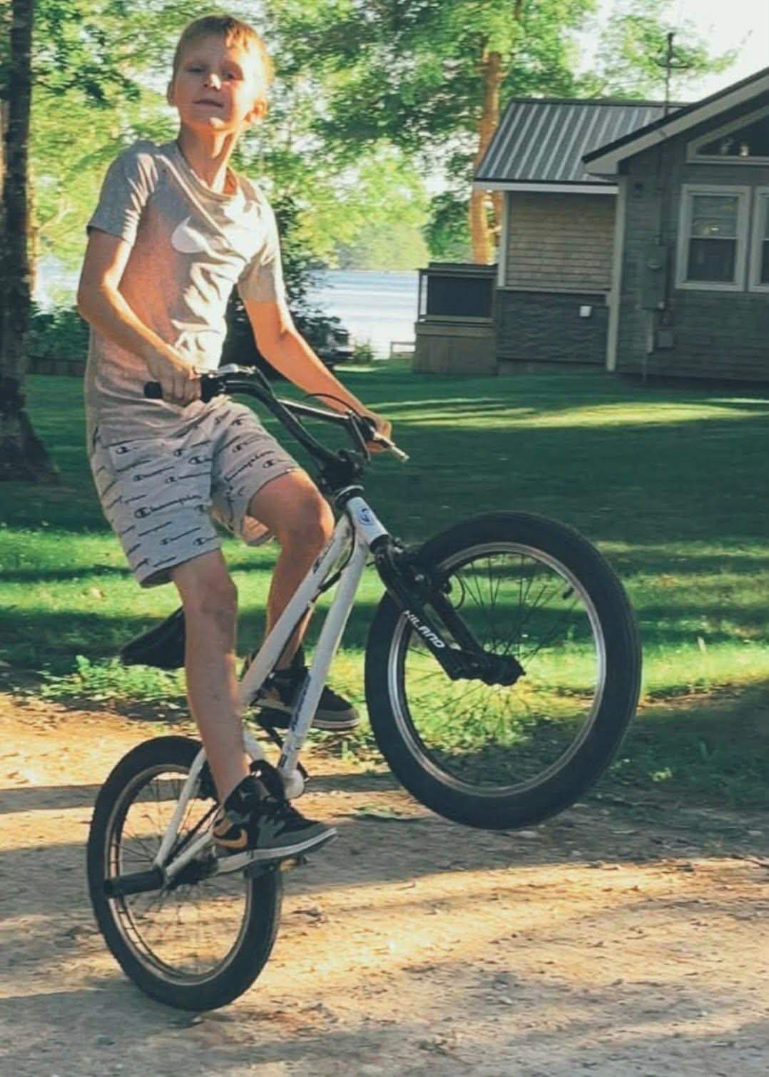 Drew Nickerson, 13, is pictured riding his bike in front of his home in Nova Scotia's Shelburne County. The teen was attacked by three dogs while riding his bike on Jan. 3, 2026 and later died in hospital.