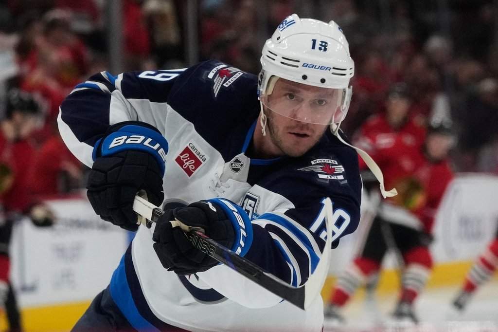 Winnipeg Jets center Jonathan Toews warms up before an NHL hockey game against the Chicago Blackhawks in Chicago, Monday, Jan. 19, 2026. (AP Photo/Nam Y. Huh).