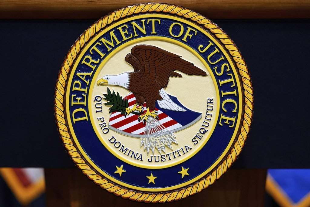FILE - The U.S. Department of Justice logo is seen on a podium before a press conference, May 6, 2025, at the Justice Department in Washington. (AP Photo/Julia Demaree Nikhinson, File).
