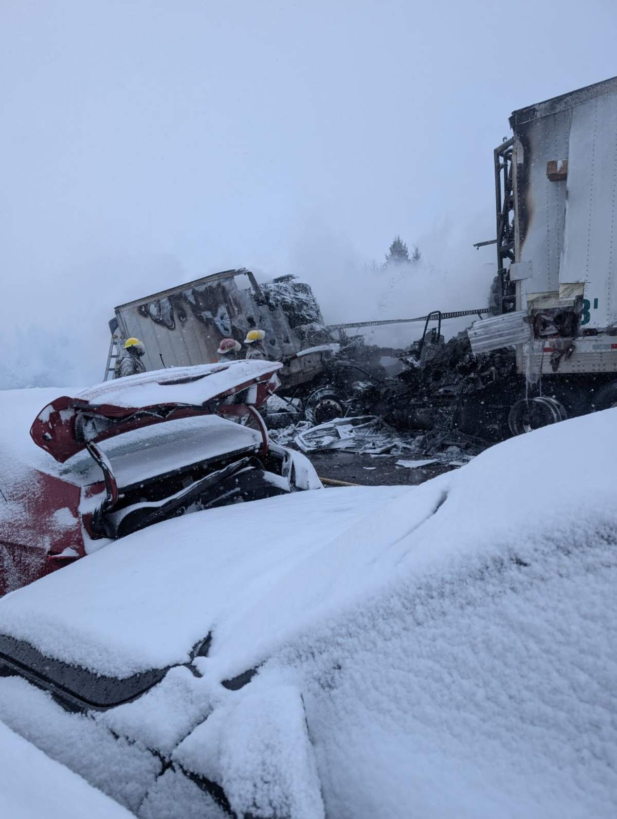 Fire crews assess damage following a fire that occurred at a collision site on Highway 401 on Jan. 27.