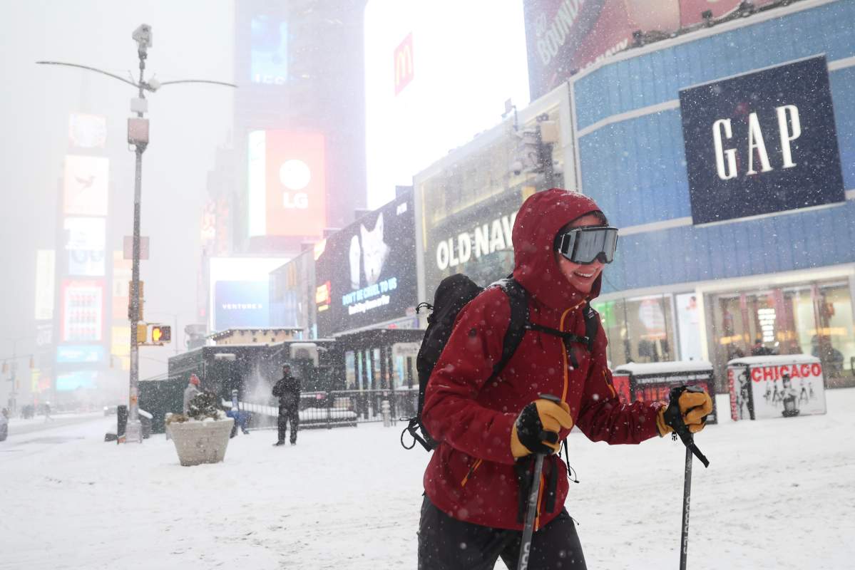 A person cross-country skis through Times Square during a winter storm, Sunday, Jan. 25, 2026, in New York.